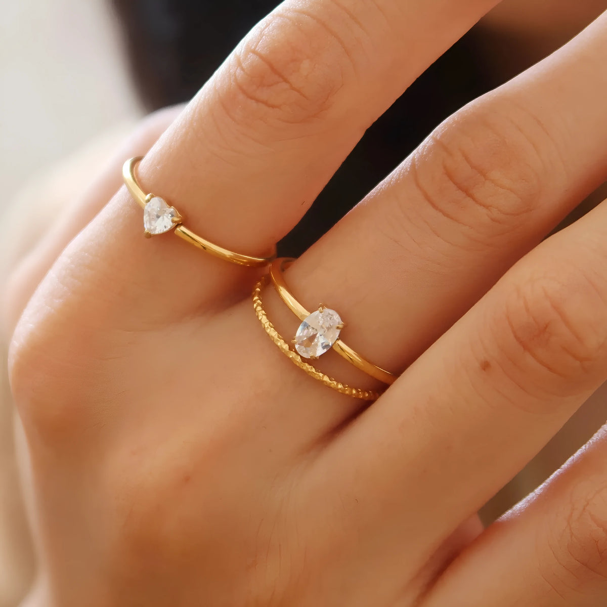 Stainless steel heart shape ring with a golden electroplated finish, shown in Heart and Oval colour variations.
