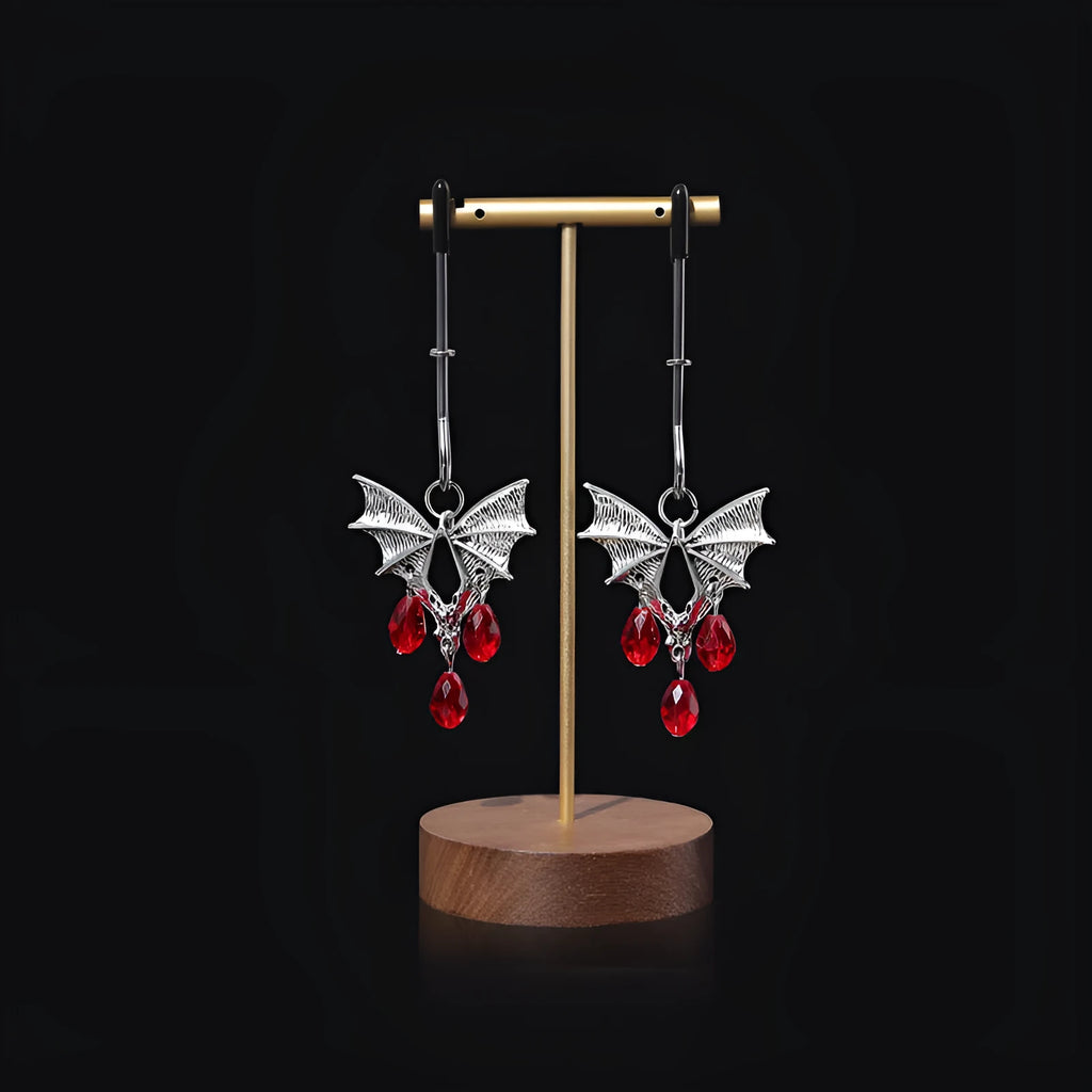Silver coloured alloy bat-shaped nipple clamp with an adjustable screw mechanism.