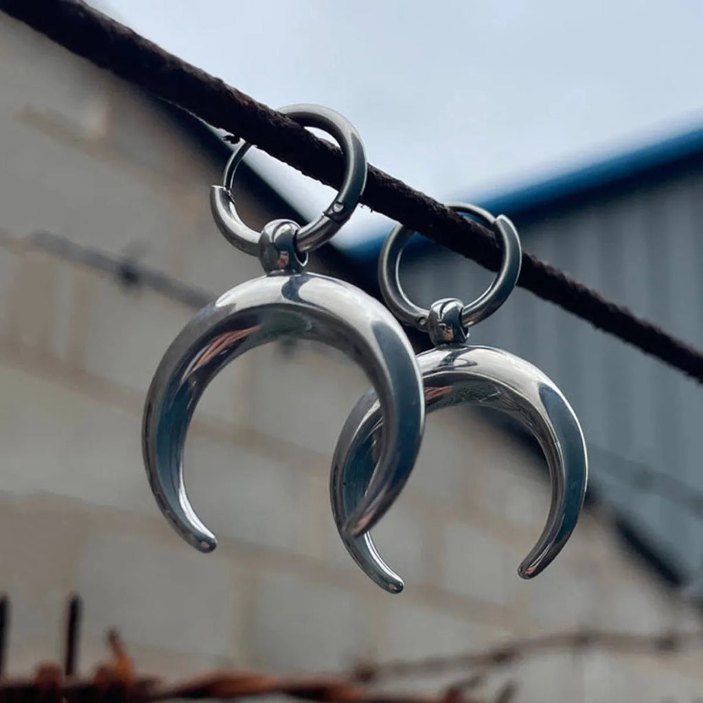 Silver geometric hoop earrings with moon motifs and ear clip fastening