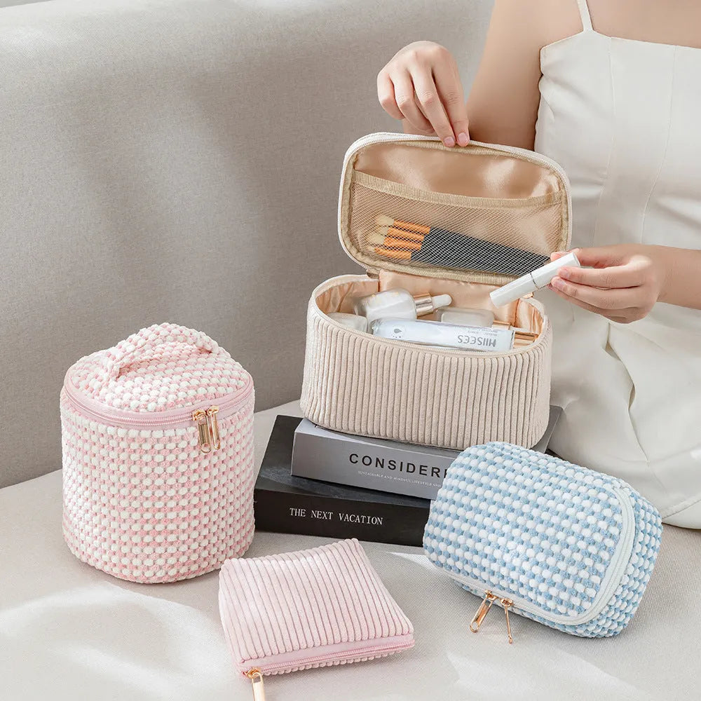 Four coordinating flannelette makeup bags in cube design with polyester construction