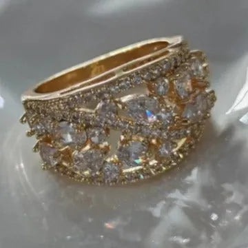 Women's round hollow fashion ring in gold or platinum plating with a blue or white cubic zirconia stone.