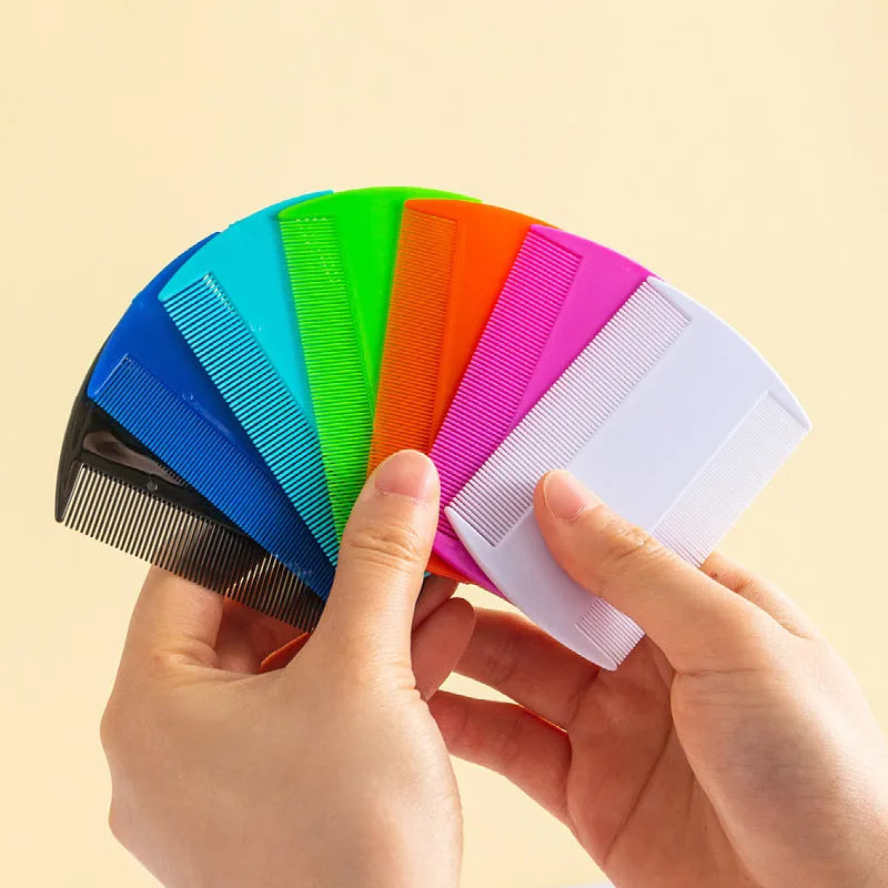 A white plastic double-edged fine-toothed lice comb on a solid colour background.