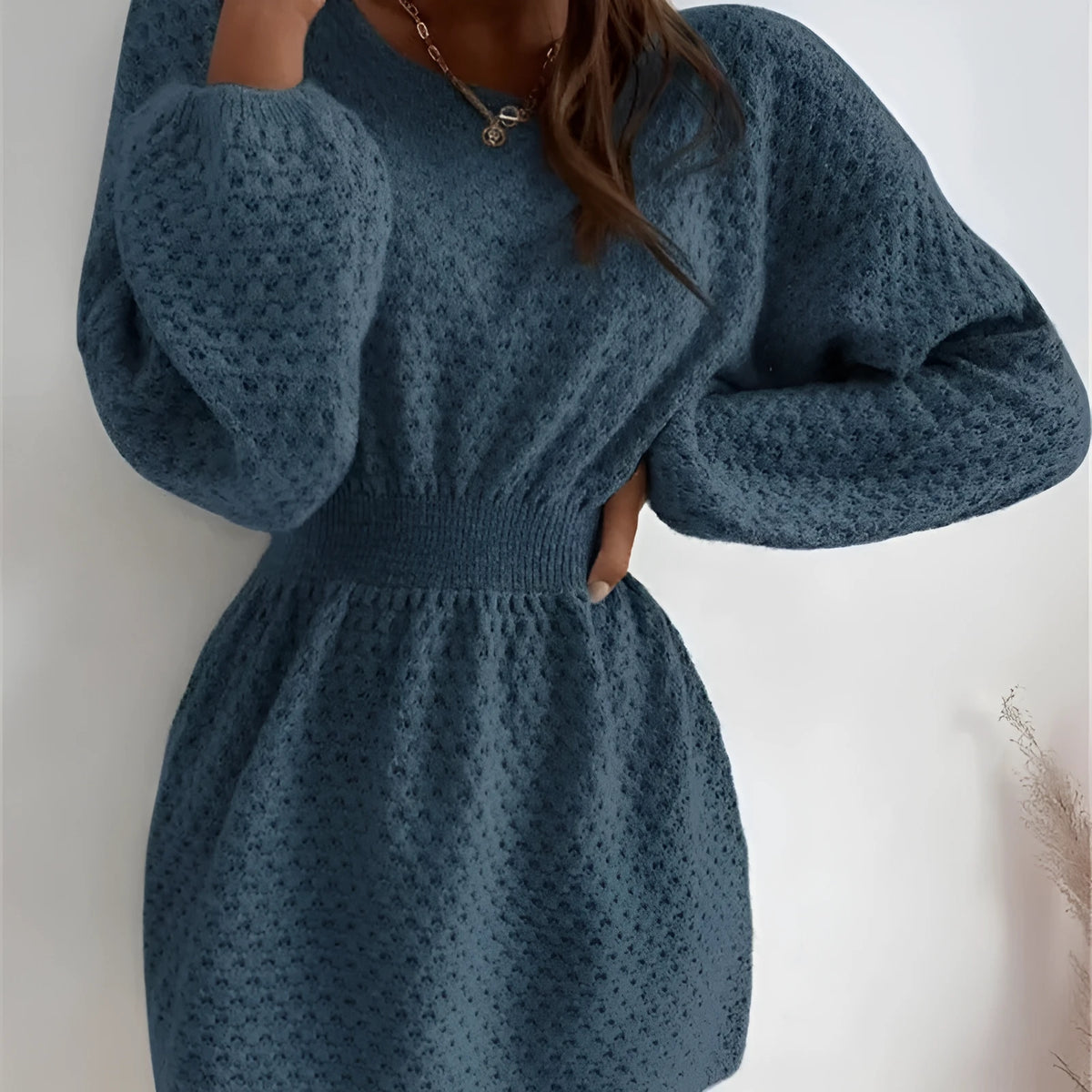 Blue women's knitted sweater dress with hand-crocheted flowers and a fitted waist.