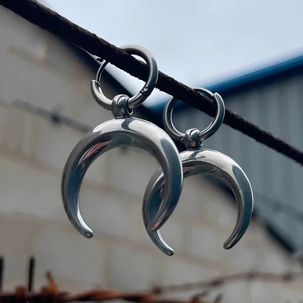 Silver geometric hoop earrings with moon motifs and ear clip fastening