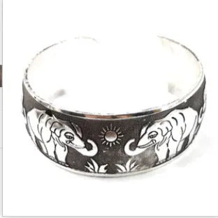 Open carved ethnic bracelet with Roman patterns in alloy metal showing elephant colour finish