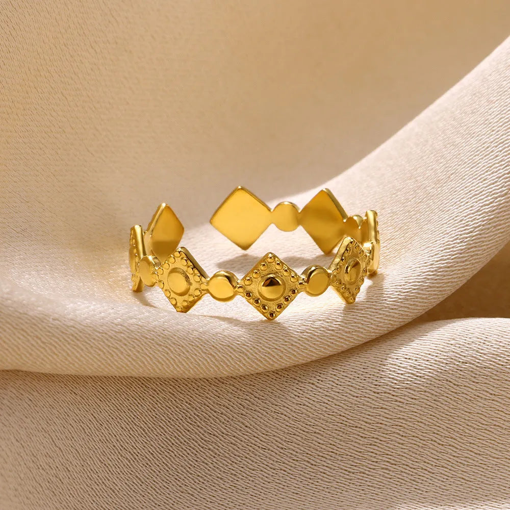 Golden diamond coloured titanium steel geometric women's ring on display