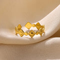 Golden diamond coloured titanium steel geometric women's ring on display