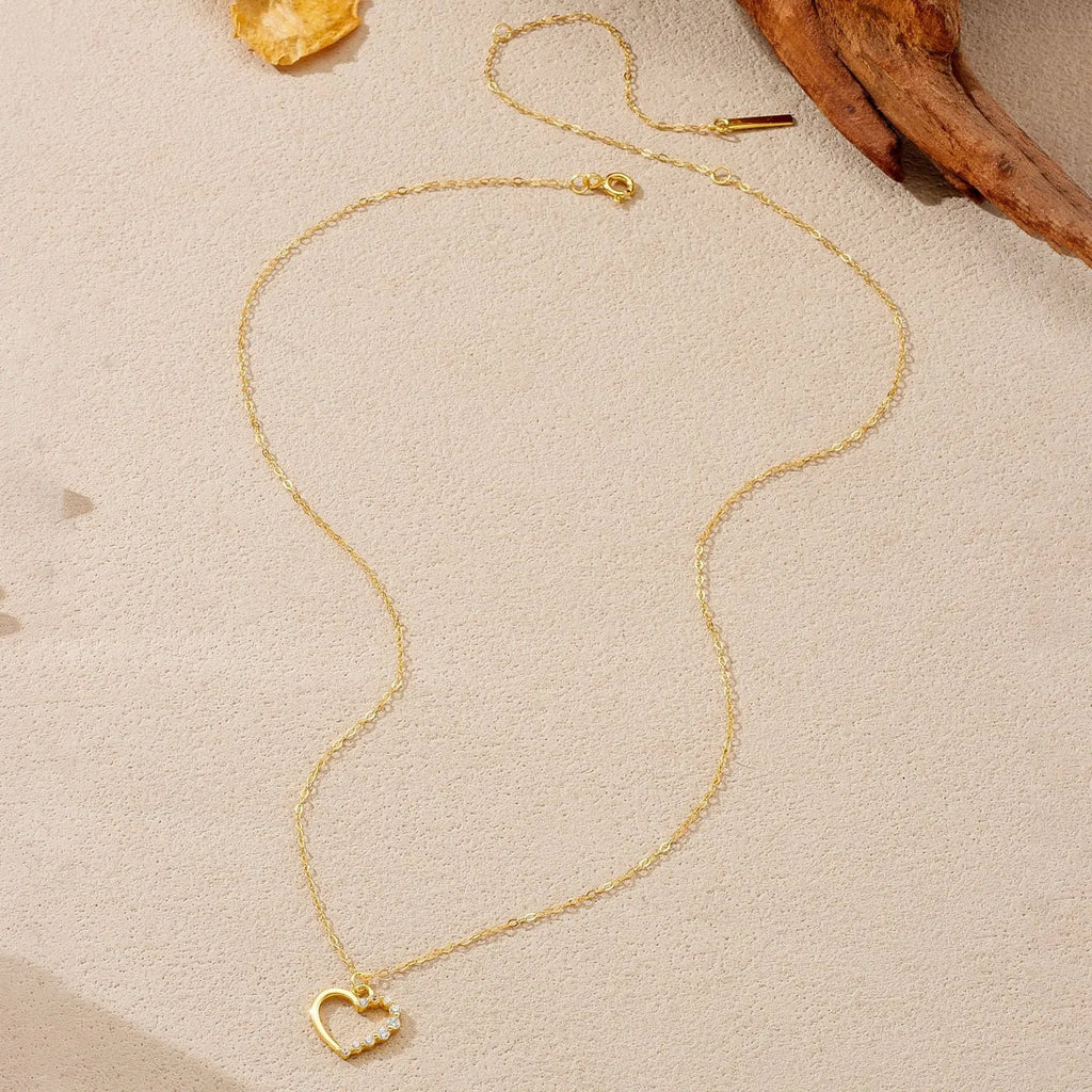 Sterling silver hollow heart necklace with circle elements, available in gold or platinum plating