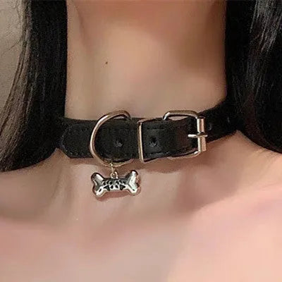 Black leather adjustable choker collar with cute bone or cat paw charm on a model.