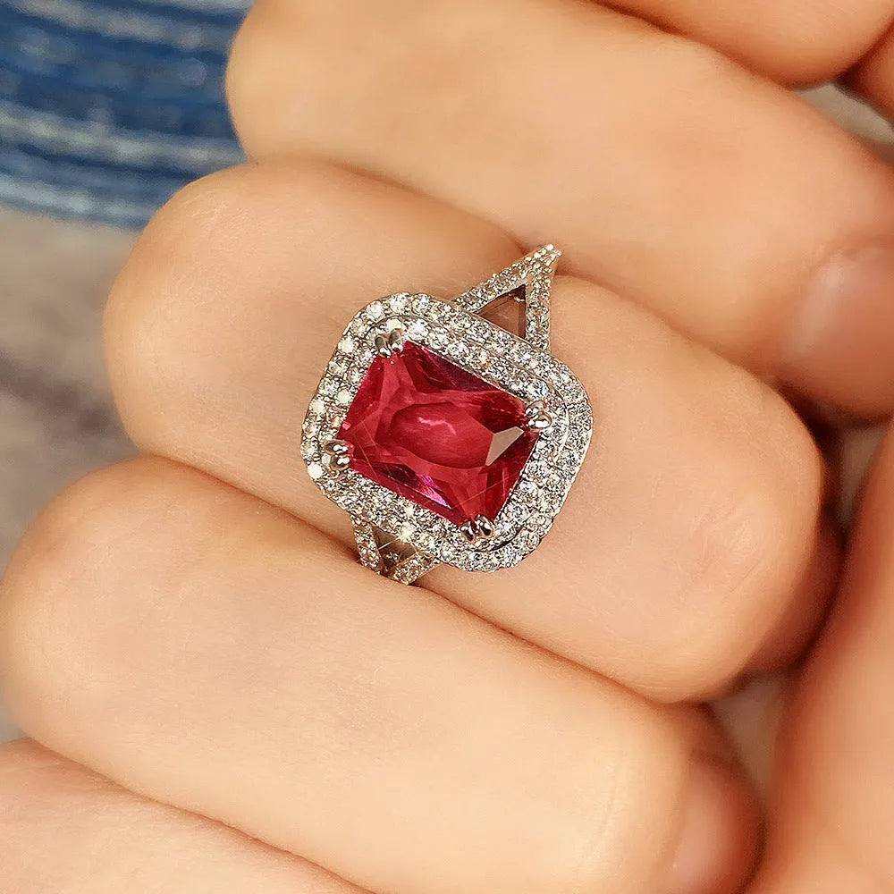 Red geometric square copper women's ring with rhinestone detailing on a white background.