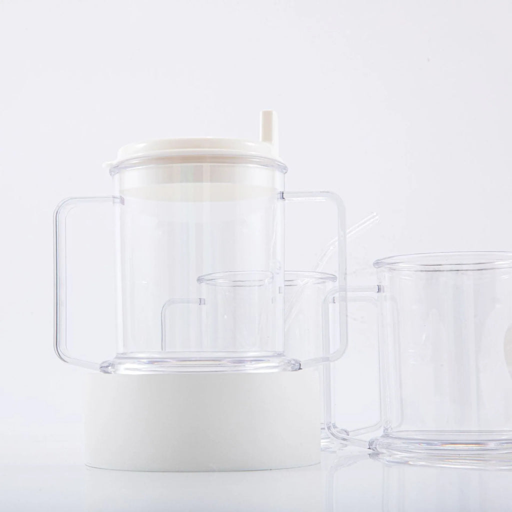 Transparent spill-proof plastic drinking cup on a table.
