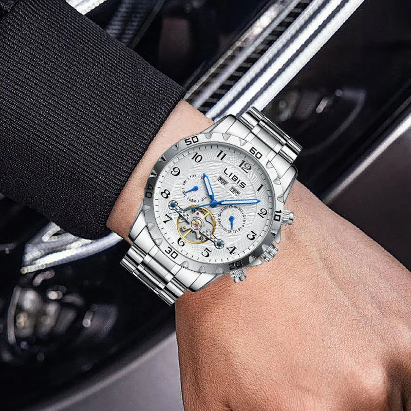 Men's silver automatic perpetual calendar watch with stainless steel strap on wrist.