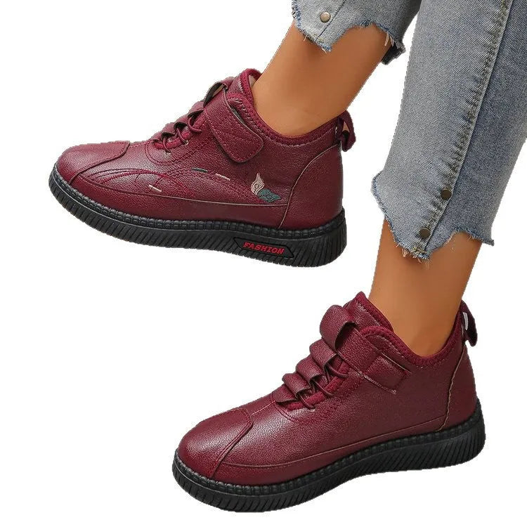 Women's black velvet house shoes with rubber soles and cotton lining, showing low tube design and hollow out decorative elements