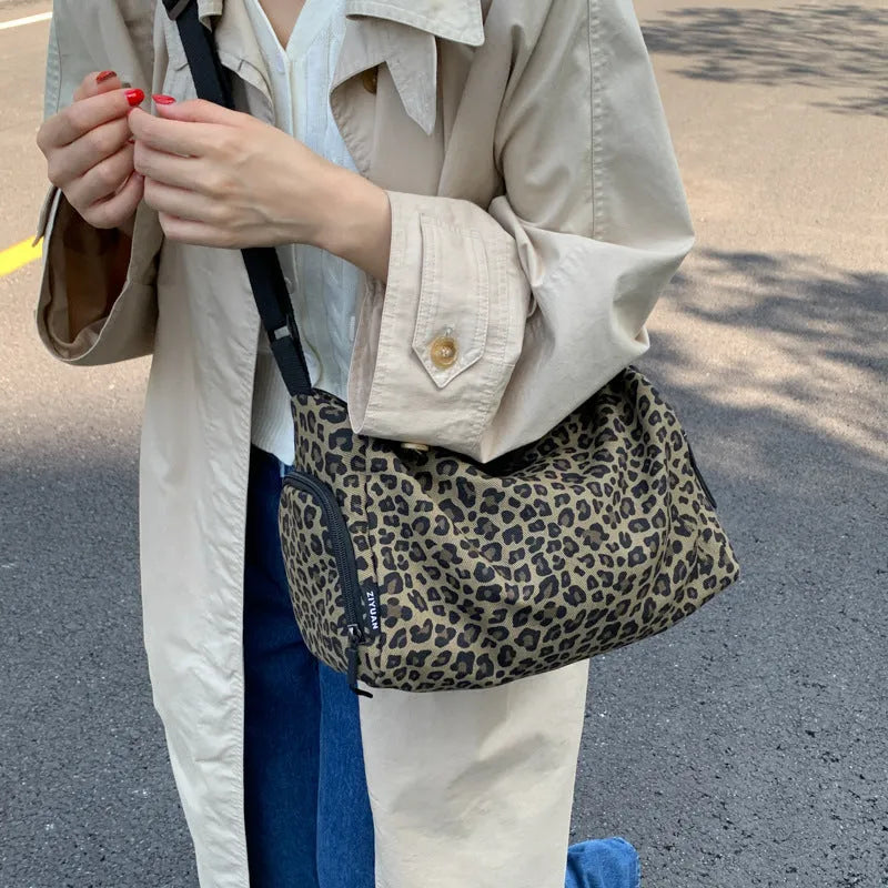 Leopard print sports style shoulder messenger bag with stitching detail and cross-body strap