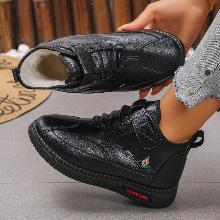 Women's black velvet house shoes with rubber soles and cotton lining, showing low tube design and hollow out decorative elements