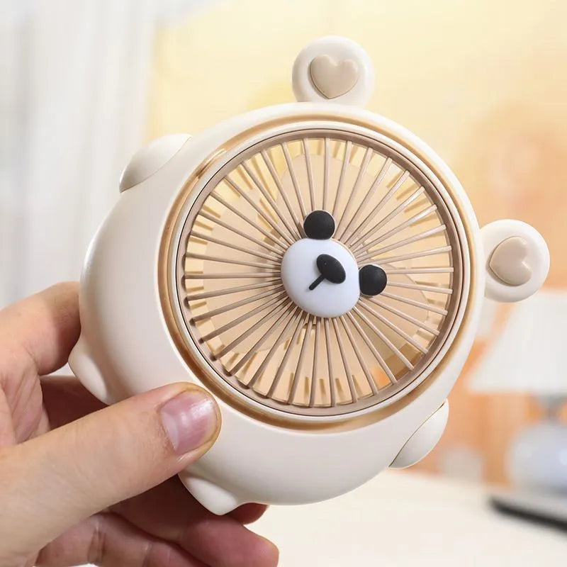Cute dog-themed USB desktop electric fan in one of six available colours on a desk.