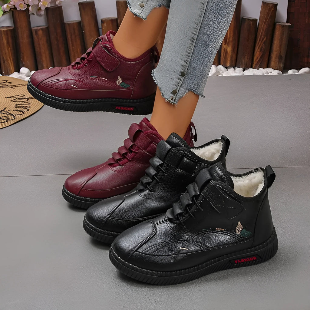 Women's black velvet house shoes with rubber soles and cotton lining, showing low tube design and hollow out decorative elements