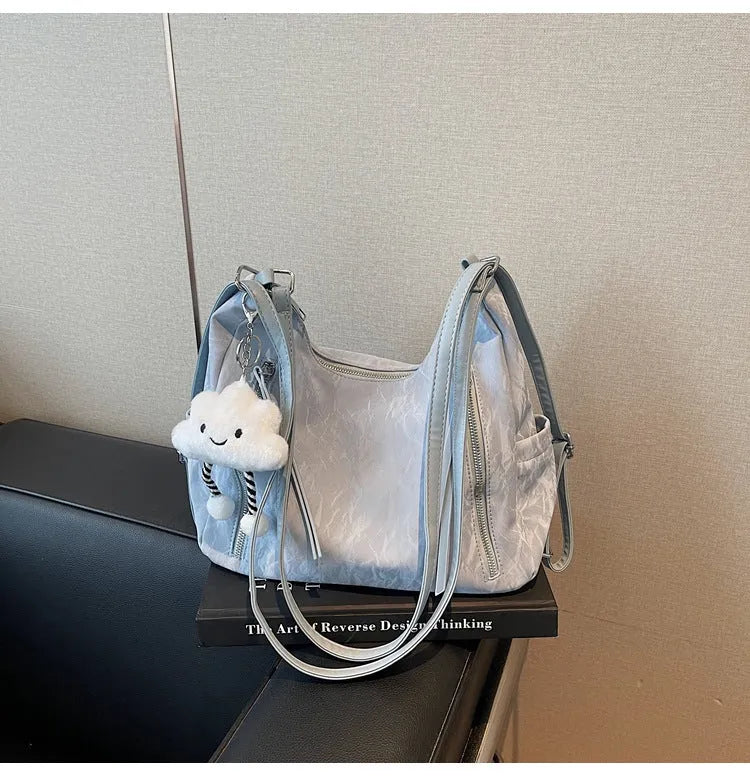 Soft black PU women's fashion backpack with a detachable silver pendant charm.