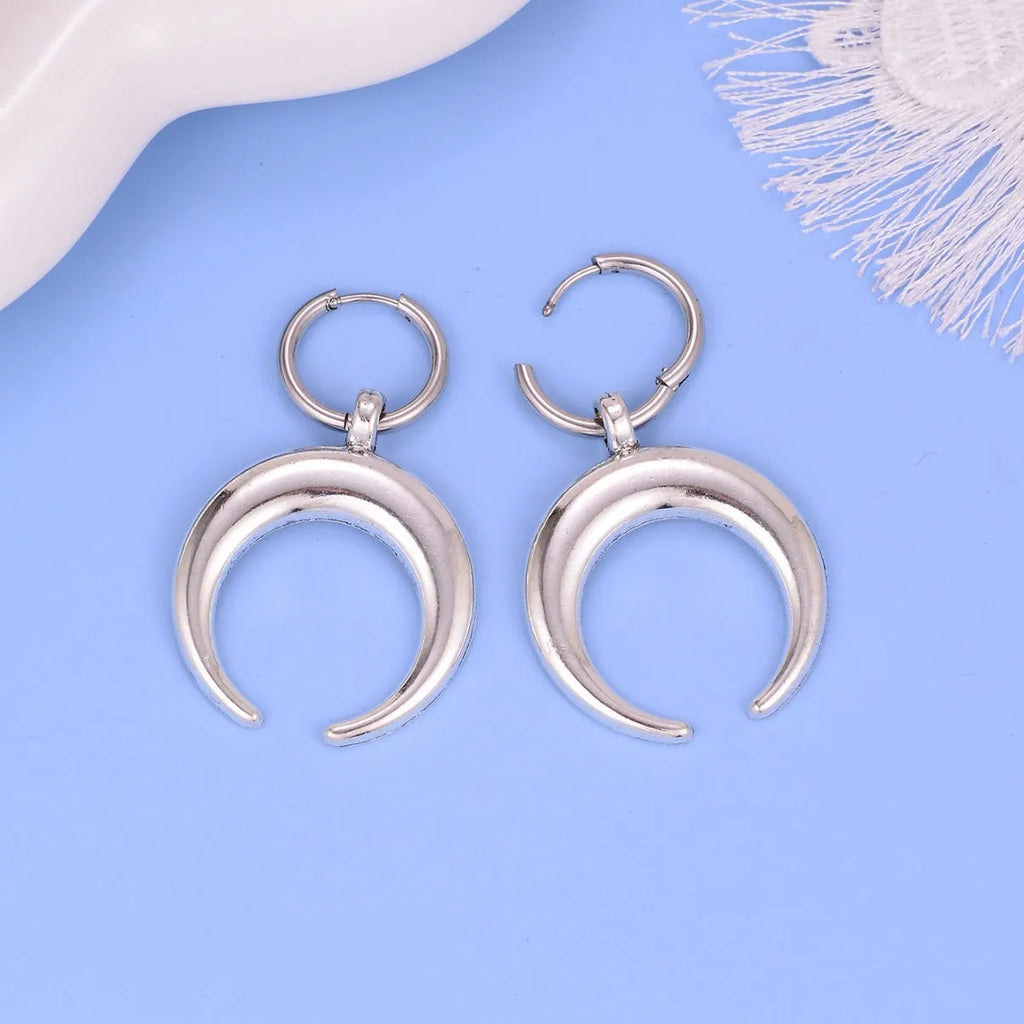 Silver geometric hoop earrings with moon motifs and ear clip fastening