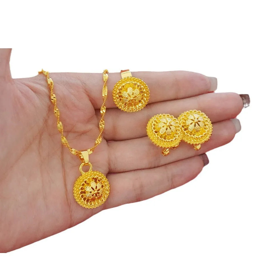 Gold-plated three-piece jewellery set with floral pendant design including necklace, earrings and ring