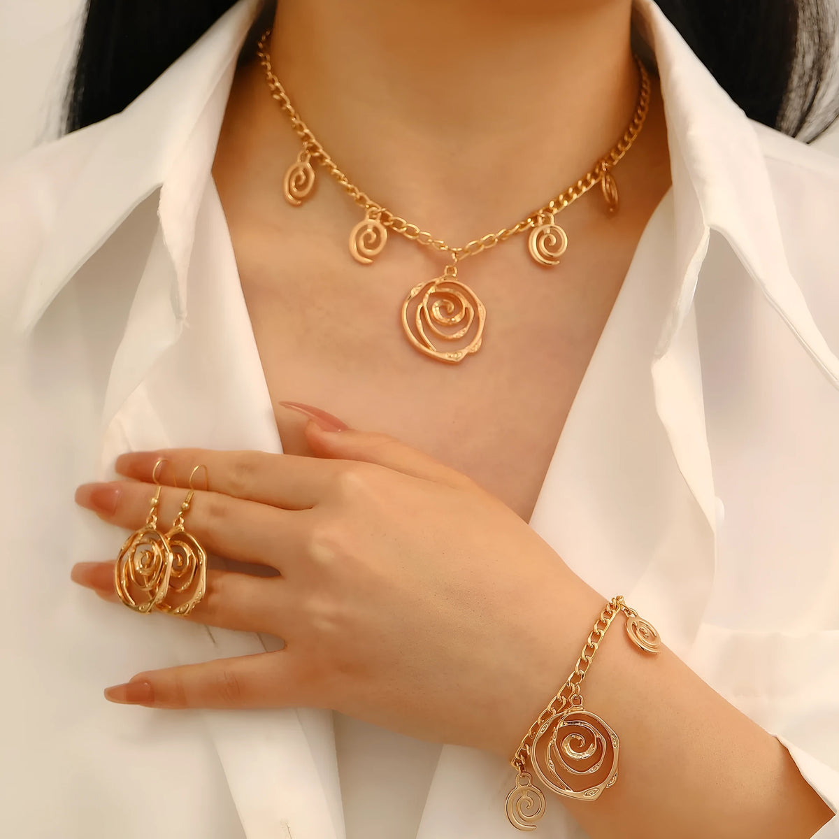Spiral donut jewellery set with geometric circle designs including adjustable necklace, bracelet and ear hooks