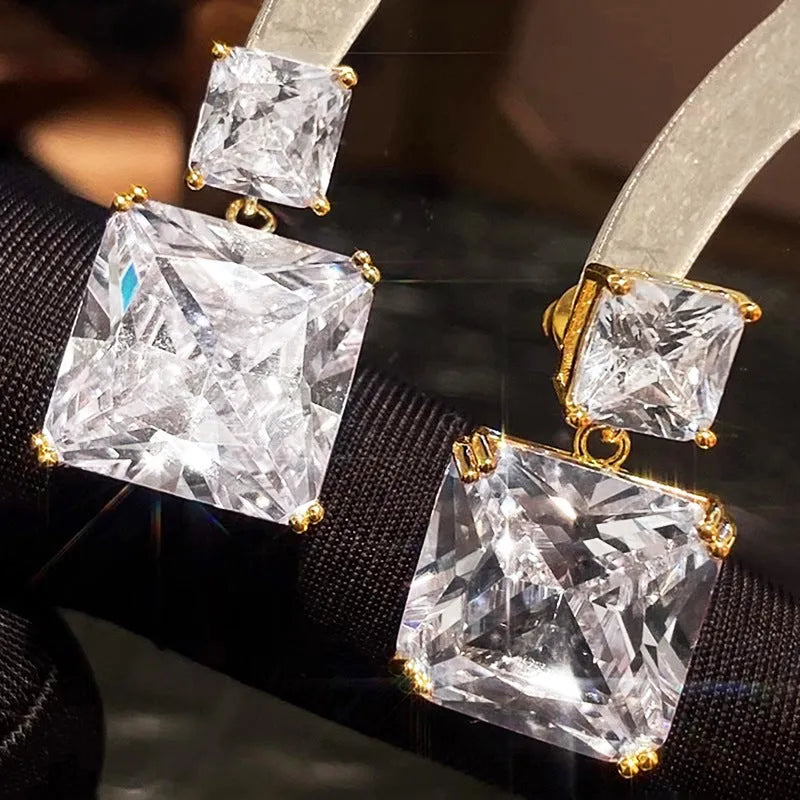 A pair of women's copper geometric square stud earrings in white gold or gold colour finish.