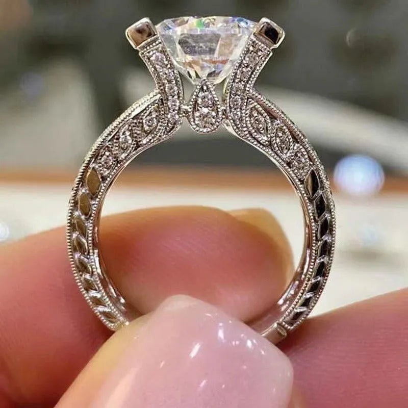 Geometric round design women's engagement ring in gold or white colour with angular patterns