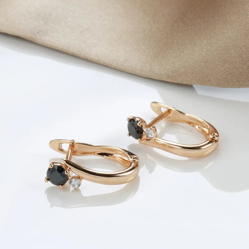 Gold geometric drop earrings with black stone inlay, retro style for women.