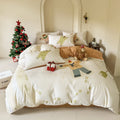 Christmas cartoon print four-piece bedding set on a bed, showing sheet, quilt cover and pillowcases.