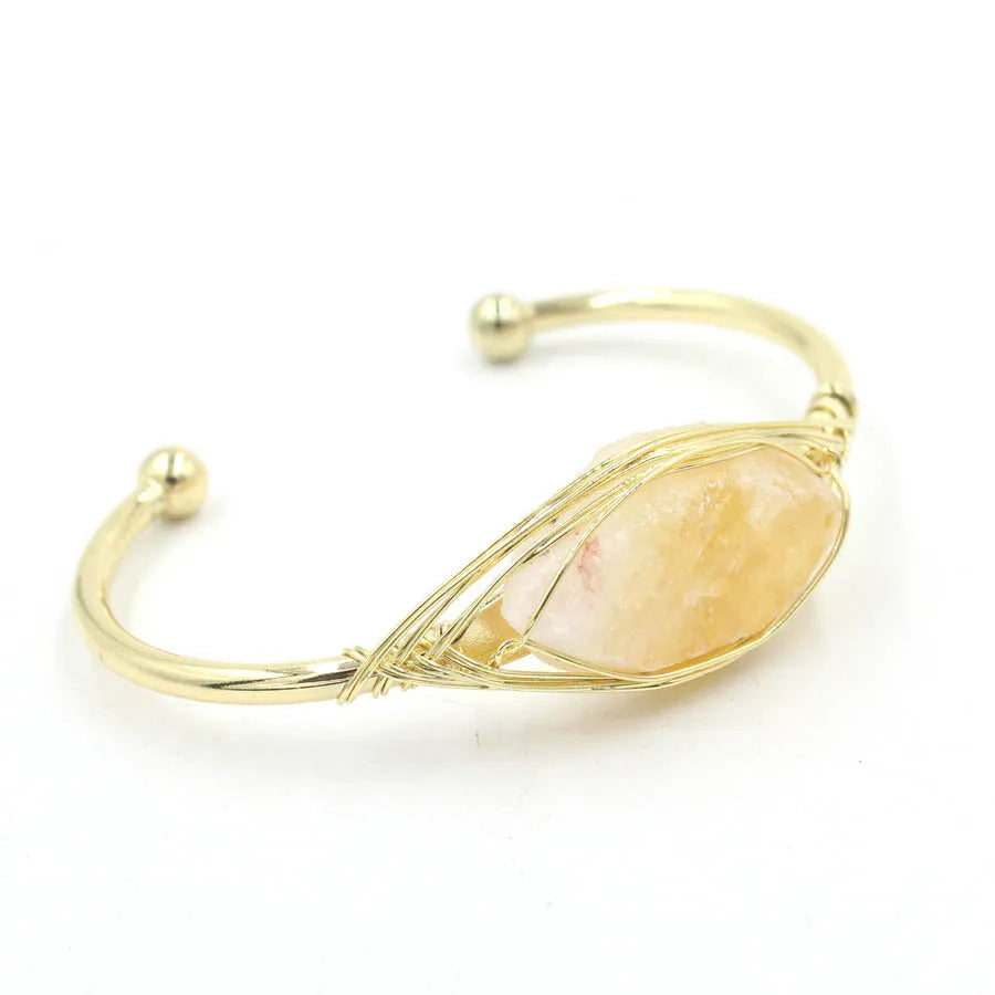 Natural raw gemstone bracelet in winding design on wrist, showing amorphous crystal stones and simple clasp.
