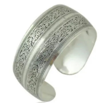 Open carved ethnic bracelet with Roman patterns in alloy metal showing elephant colour finish