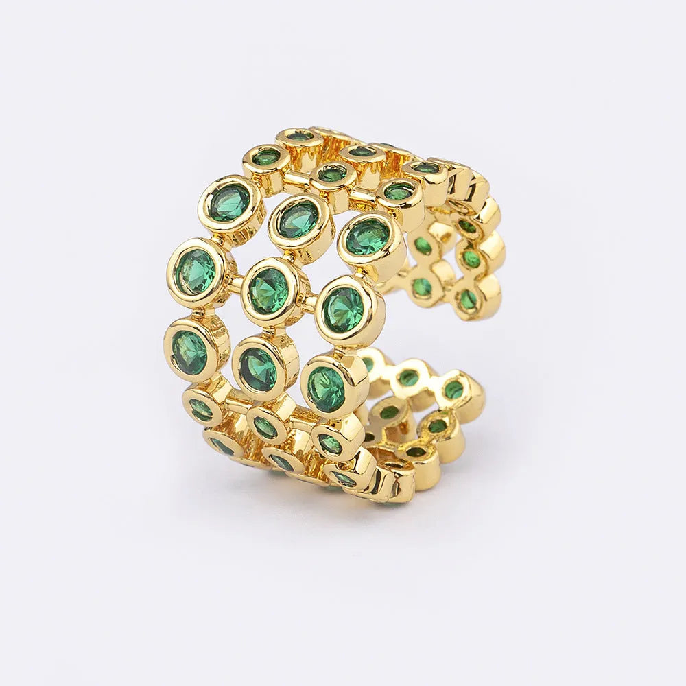Copper ring with 18K gold plating showing three-layer design and green zircon stones
