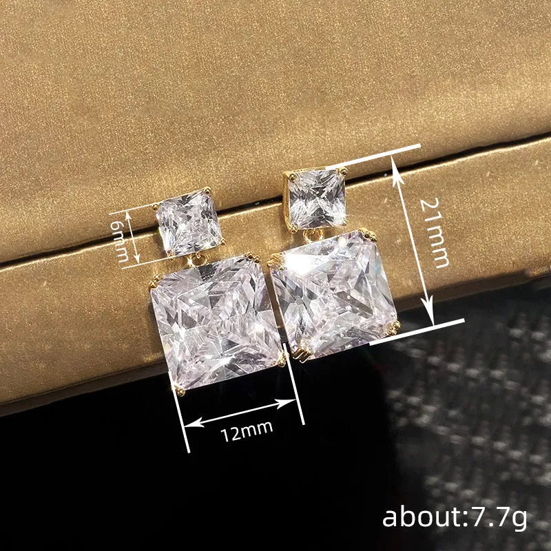 A pair of women's copper geometric square stud earrings in white gold or gold colour finish.