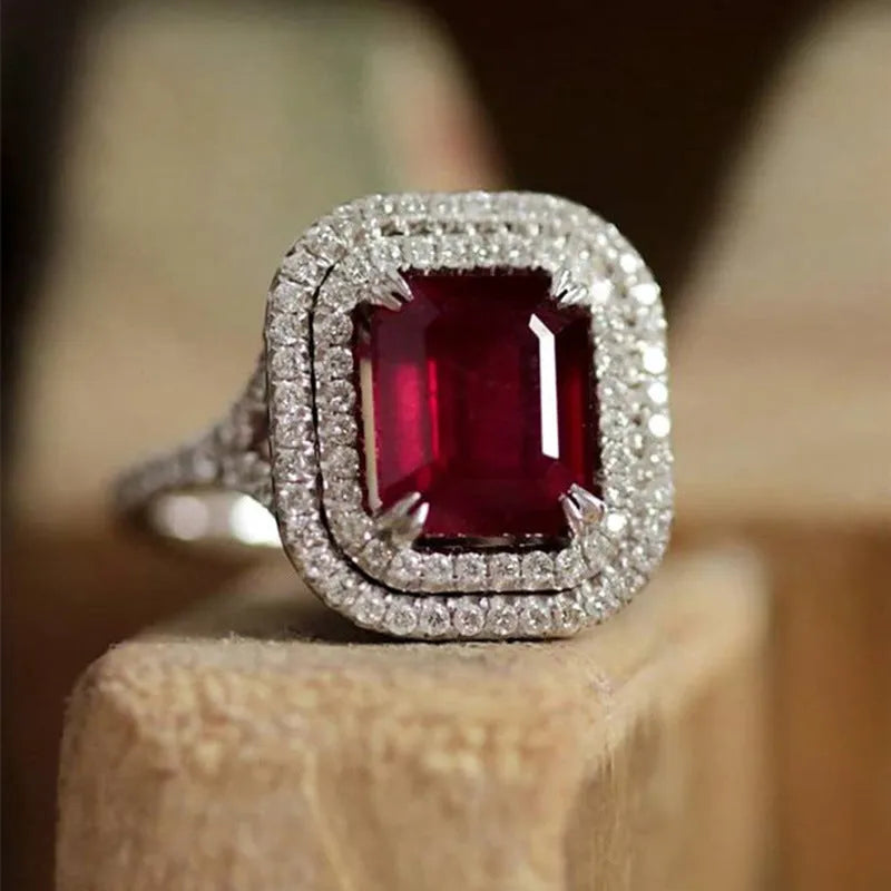 Red geometric square copper women's ring with rhinestone detailing on a white background.