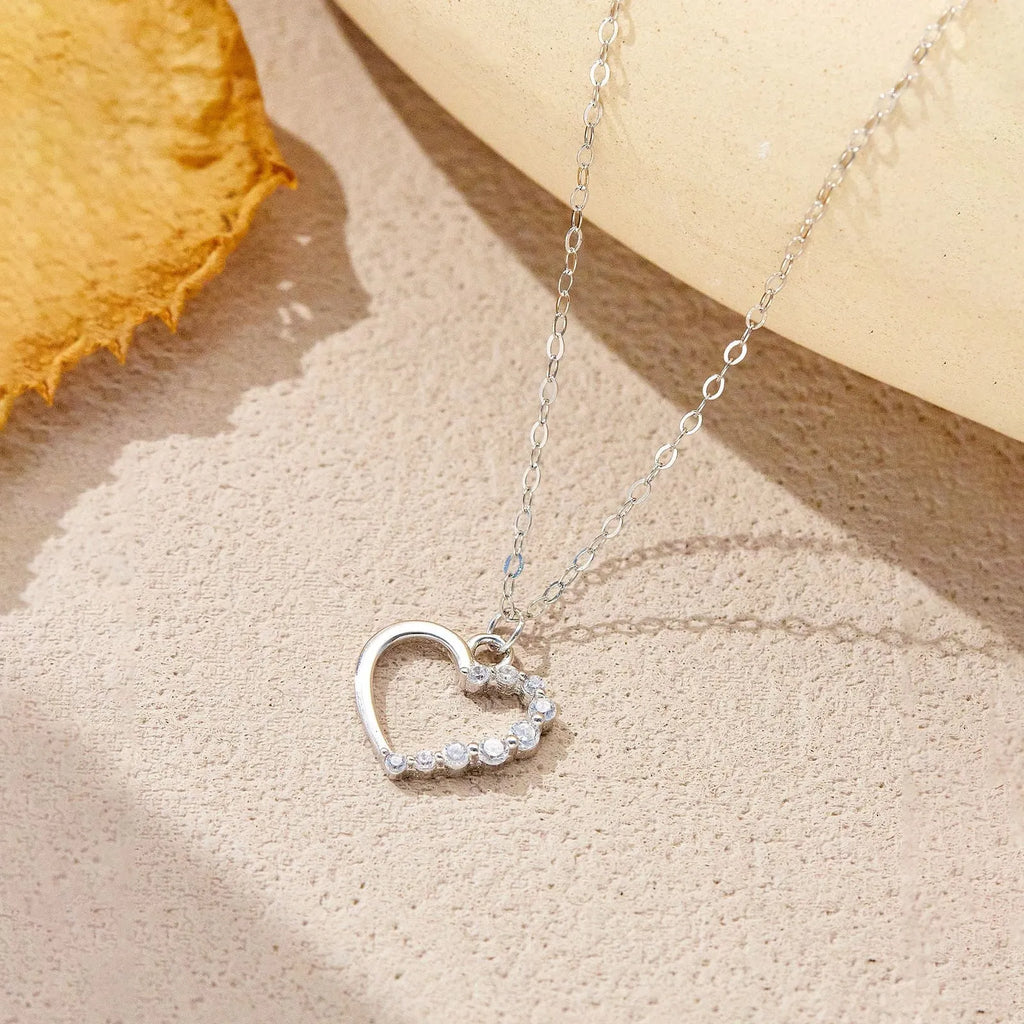 Sterling silver hollow heart necklace with circle elements, available in gold or platinum plating