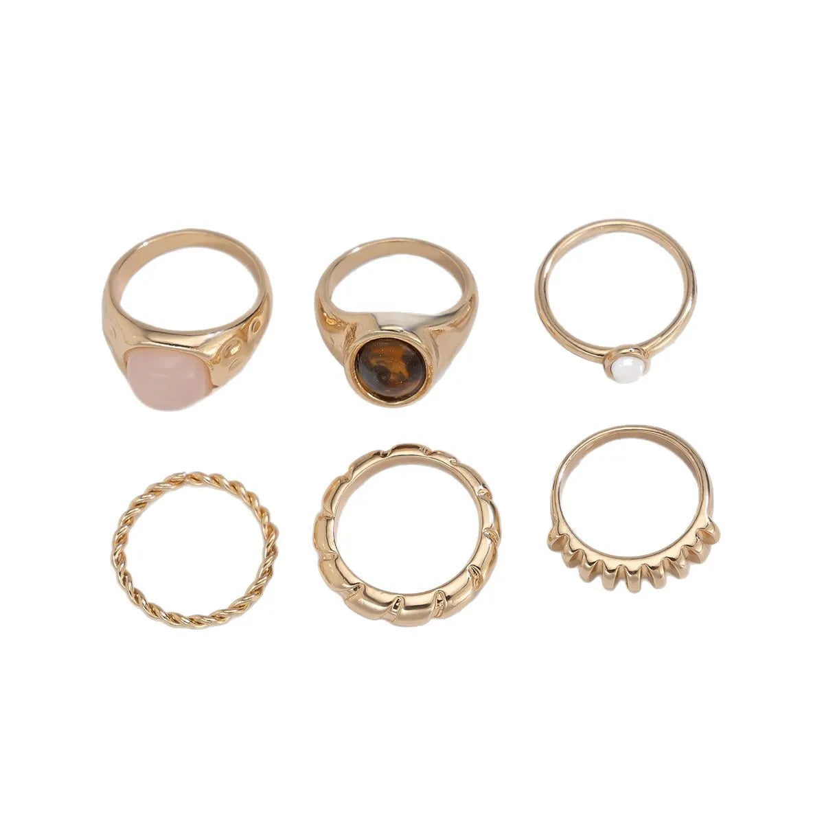 Six geometric alloy rings with irregular shapes in light gold electroplated finish arranged as a set
