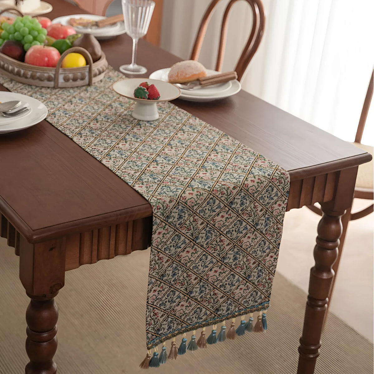 Dark blue striped floral jacquard table runner laid flat on a wooden dining table.