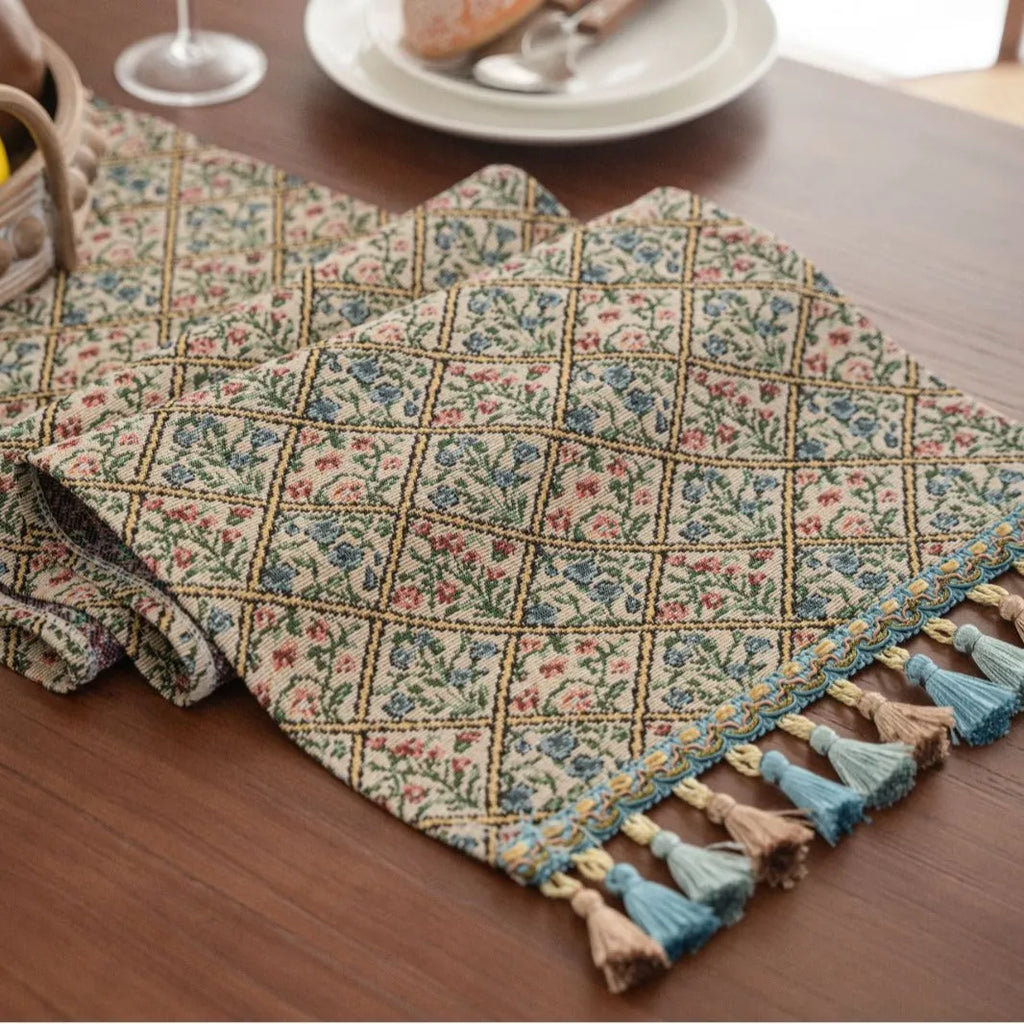Dark blue striped floral jacquard table runner laid flat on a wooden dining table.
