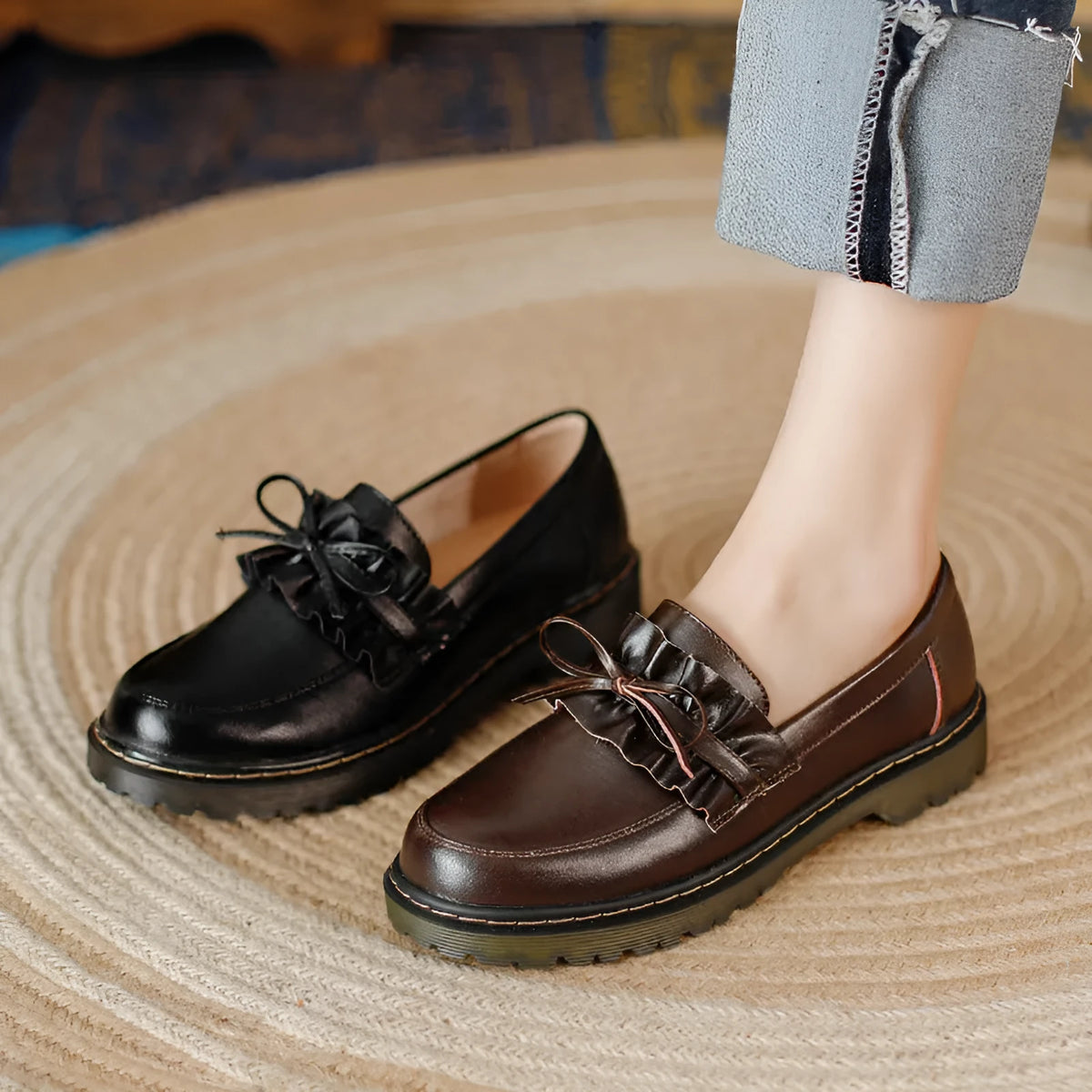Women's black leather chunky heel shoes with a round toe and low-top design.