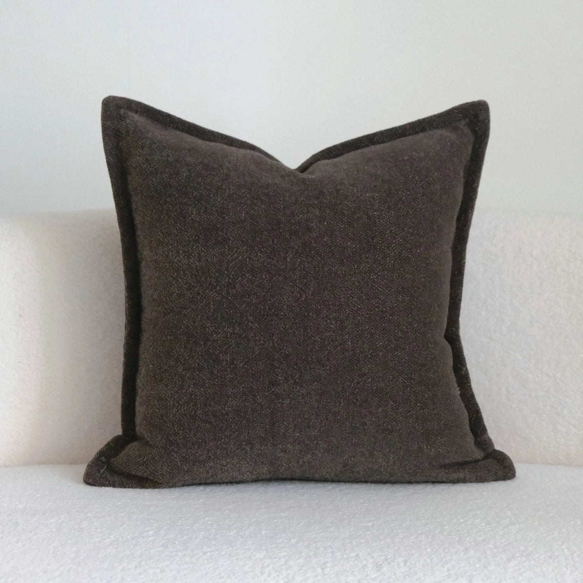 Coffee brown striped mid-century decorative cushion pillow on a grey sofa