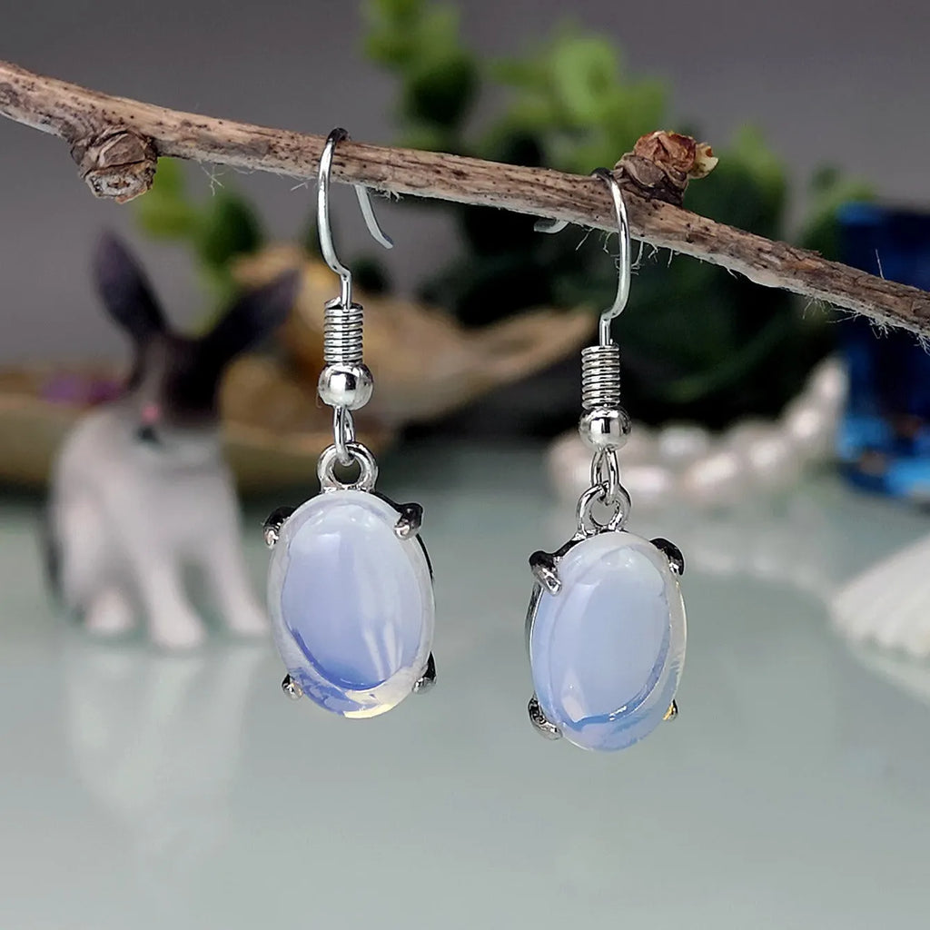 Moonlight white opal drop earrings with cross design and ellipse elements
