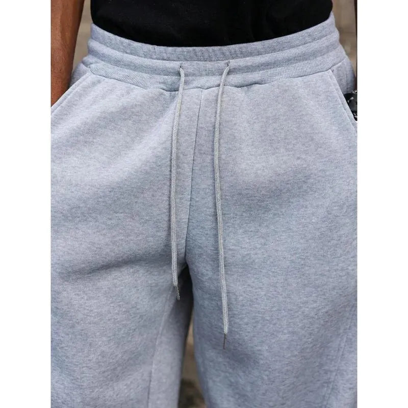 Man wearing dark grey high waist straight leg casual cropped pants made from bamboo fibre.