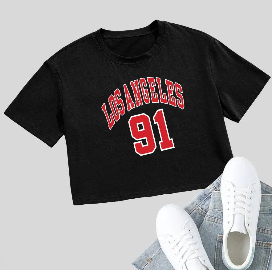 A loose fit black cotton T-shirt with white printed English letters and an exposed navel cut.