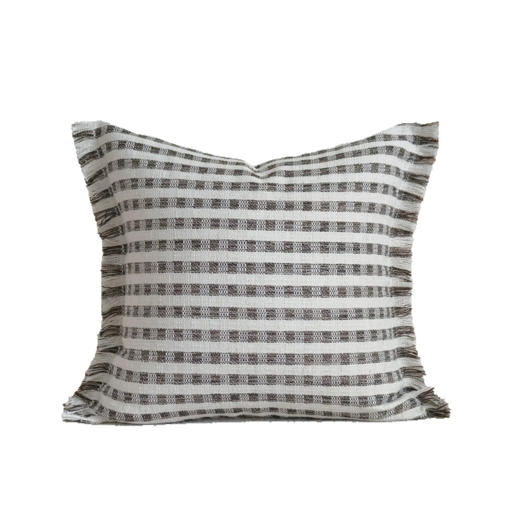 Coffee brown striped mid-century decorative cushion pillow on a grey sofa