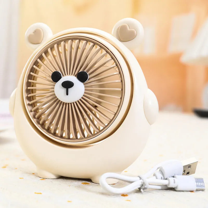 Cute dog-themed USB desktop electric fan in one of six available colours on a desk.