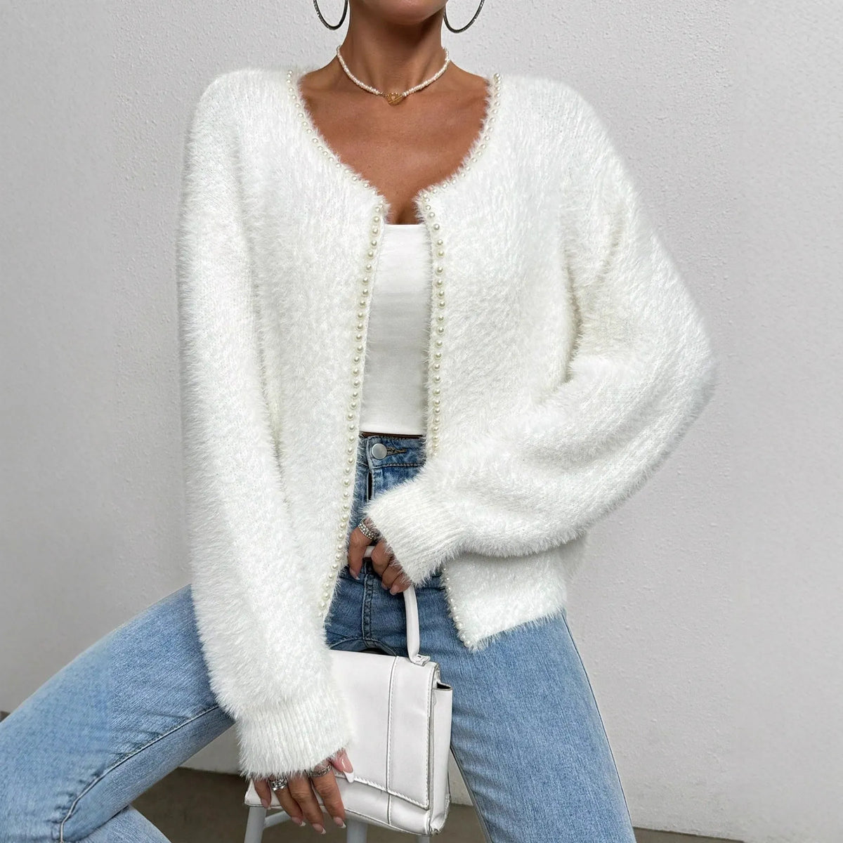 White women's cardigan with V-neck and bead detailing on polyester knit fabric