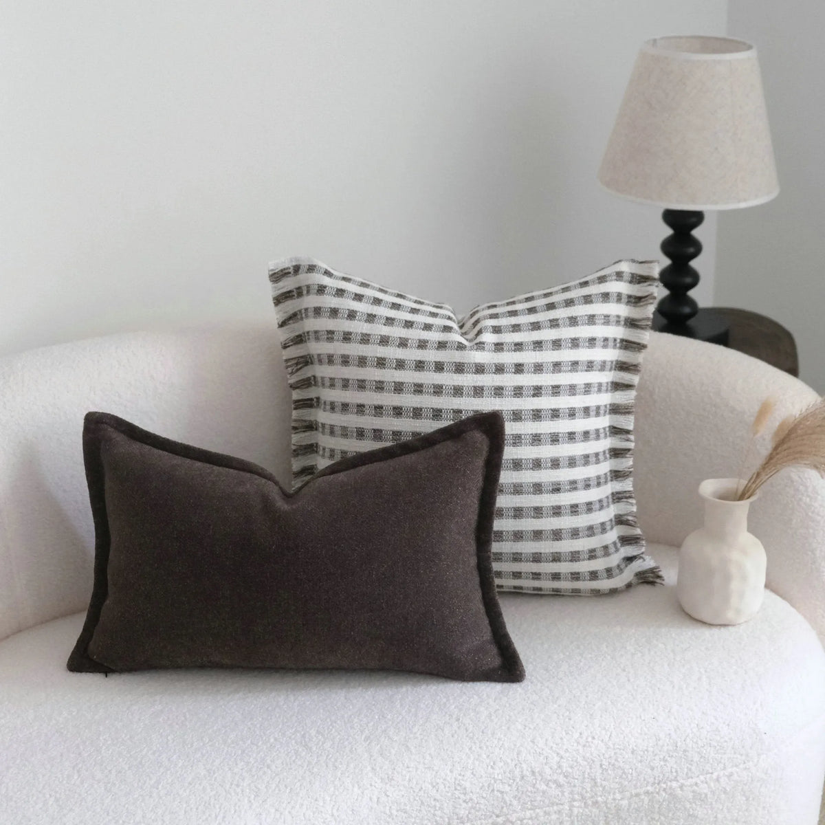 Coffee brown striped mid-century decorative cushion pillow on a grey sofa