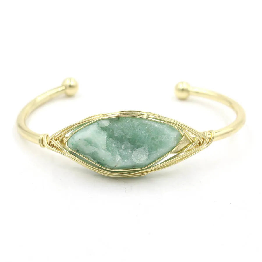 Natural raw gemstone bracelet in winding design on wrist, showing amorphous crystal stones and simple clasp.