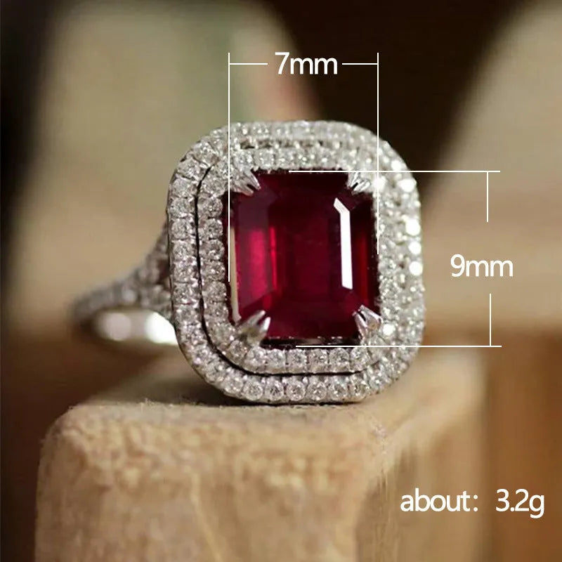 Red geometric square copper women's ring with rhinestone detailing on a white background.