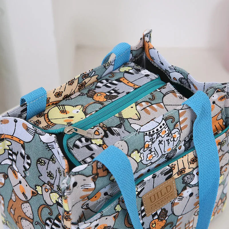 Women's printed canvas handbag with aluminium frame in floral and cat design options